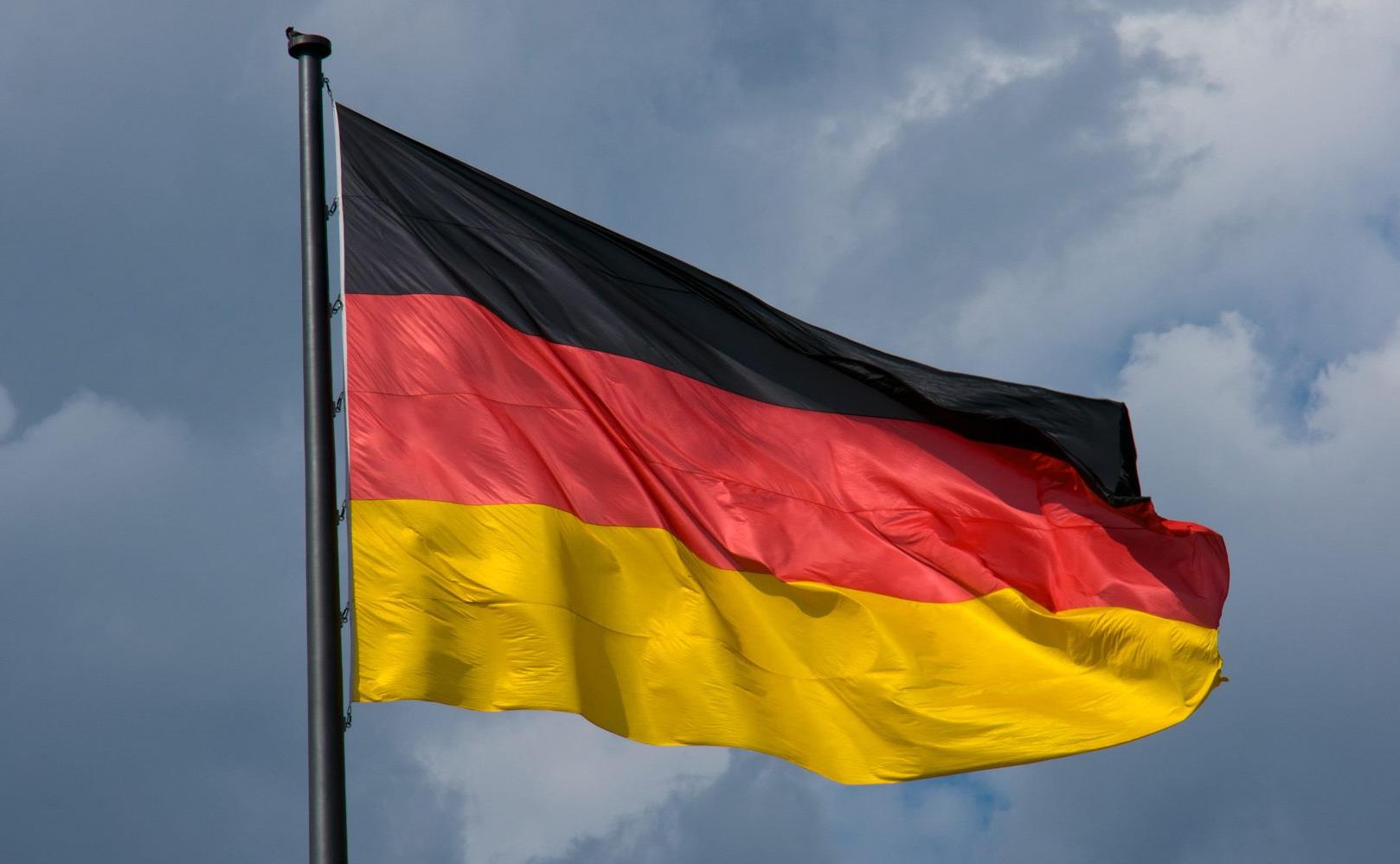 german-flag-in-front-of-dark-clouds-PDLQF4S-1800x1000.jpg
