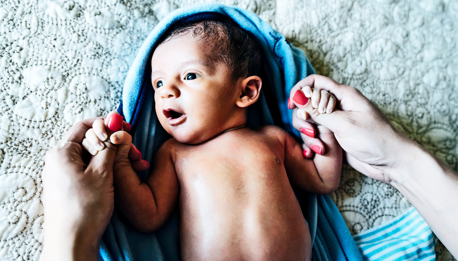 baby-on-blanket-with-mom_1600.jpg