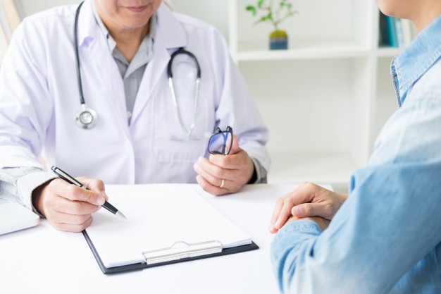 patient-listening-intently-to-a-male-doctor-explaining-patient-symptoms-or-asking-a-question-as-they-discuss-paperwork-together-in-a-consultation_1423-1367.jpg